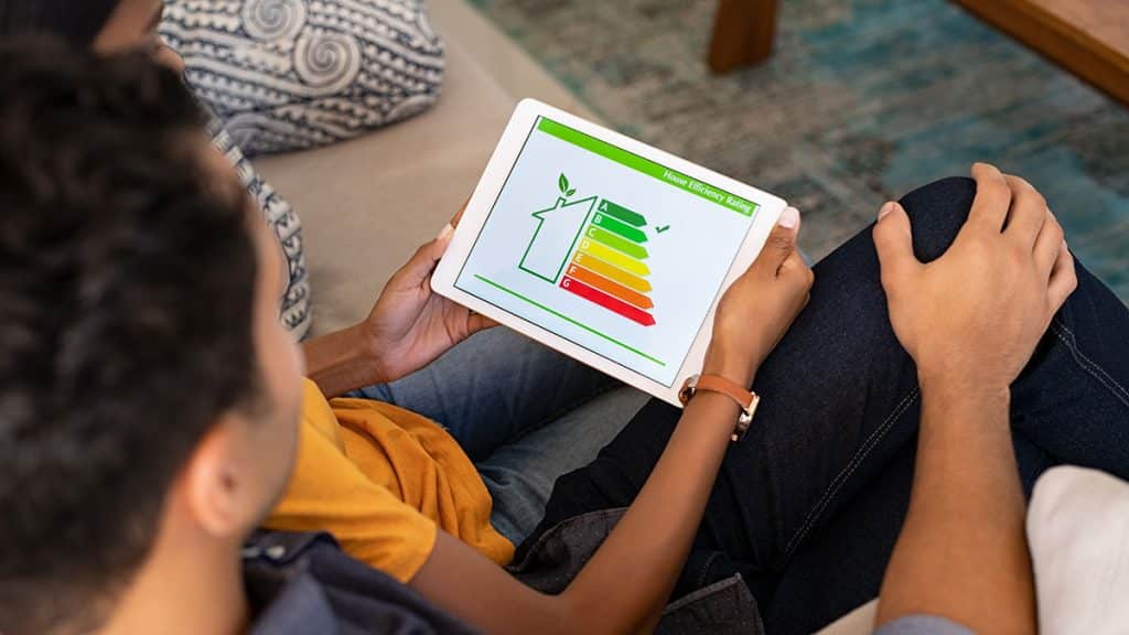 Couple viewing energy efficiency rating after new ac installation.