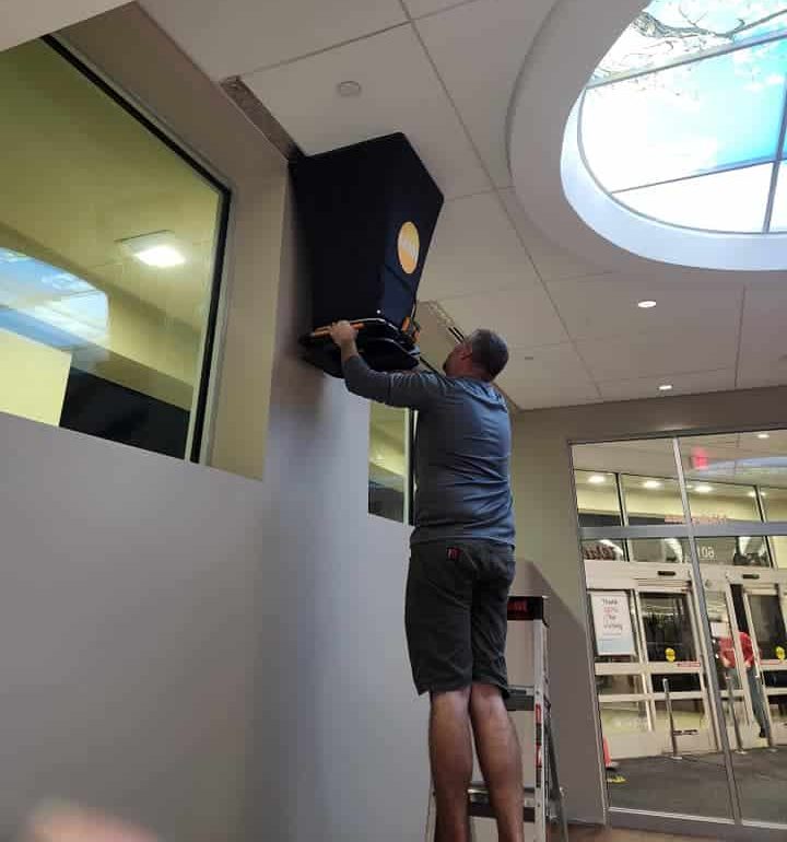 Michael Meredith performing an HVAC Test and Balance in a Commercial Building